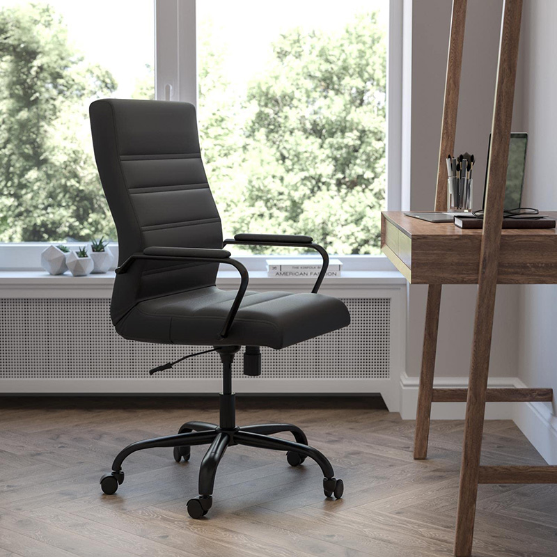 Modern black ergonomic office chair in a minimalist home workspace near a large window with a scenic view.