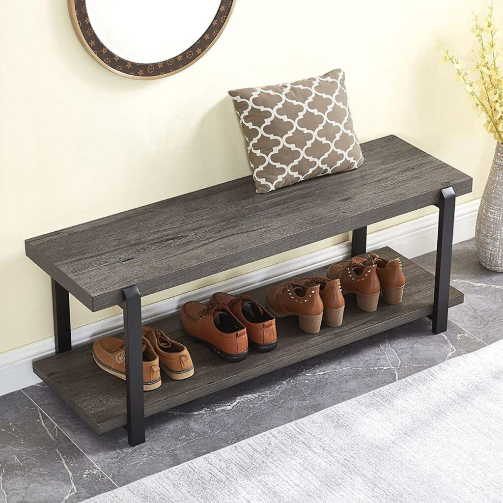 Wooden shoe bench with a cushion and shoes neatly placed on the lower shelf, positioned in a well-lit entryway.