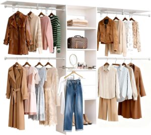 A clean white modular closet system featuring hanging rods for coats and dresses, shelving for folded clothes, and a central vanity area with a mirror.